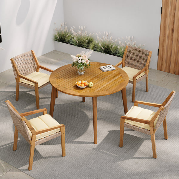 Acacia and Wicker Outdoor Dining Set — Round acacia table and four wicker armchairs with cream cushions for outdoor dining