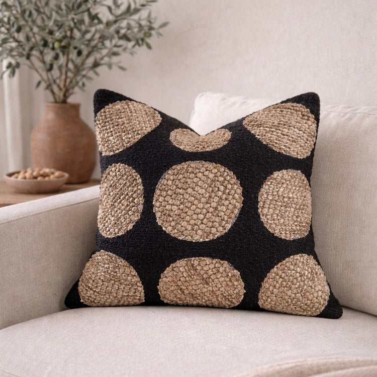 Woven Dot Textured Pillow Cover — Raised natural-fiber medallions on a deep charcoal woven ground, hidden zipper closure