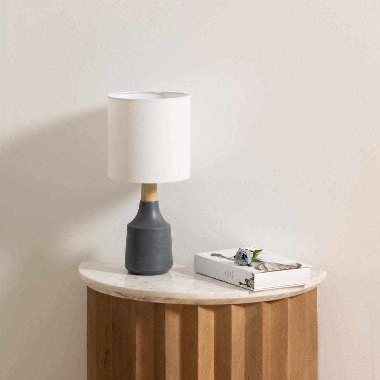 Matte Resin Table Lamp — Sculptural charcoal base with wood-tone collar and diffusing cloth drum shade