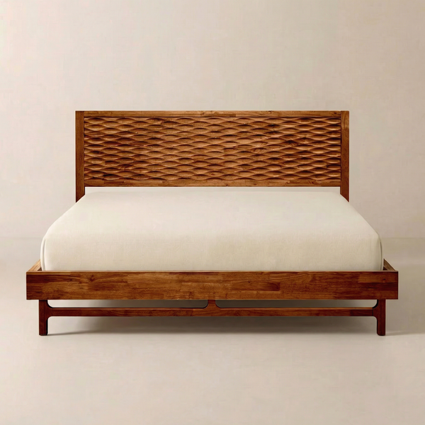 Relief-Carved Wood Platform Bed Frame — Relief-carved headboard on a grounded low platform with tapered legs
