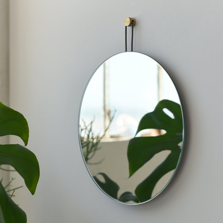Brass-Hook Round Wall Mirror — Slim-framed round mirror with brushed brass hook and looped dark cord