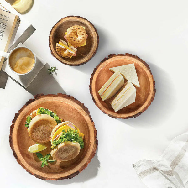Live-Edge Mango Wood Bark Bowl Set — Set of three graduated mango wood bowls with raw live-edge bark exteriors
