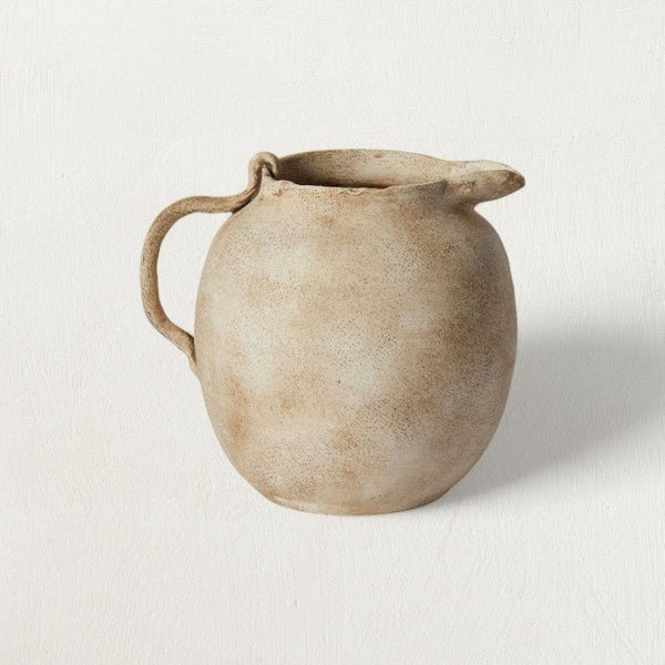Speckled Matte Ceramic Pitcher — Hand-formed ceramic pitcher in matte off-white with warm earth-tone speckle