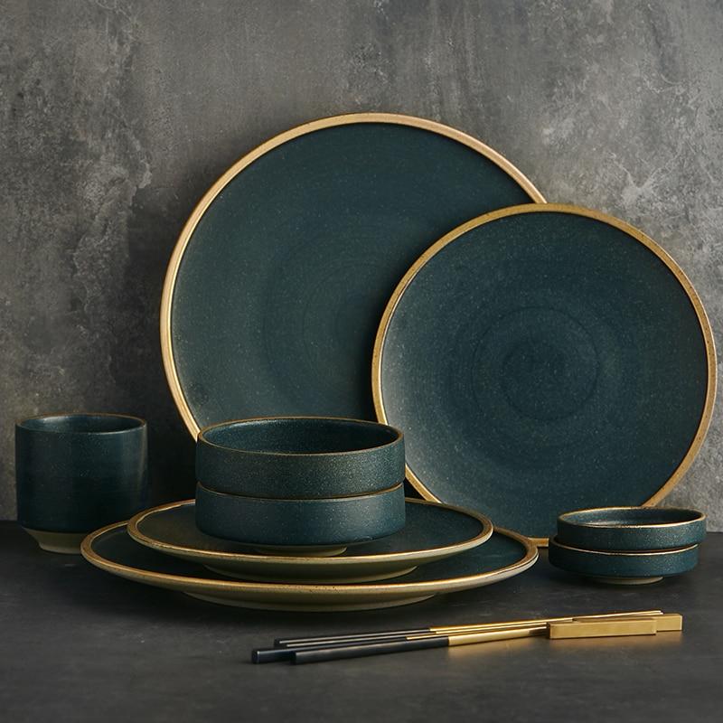 Matte Porcelain Dinnerware Set — Matte porcelain dinnerware with a hand-applied warm gold rim, in deep tonal glaze