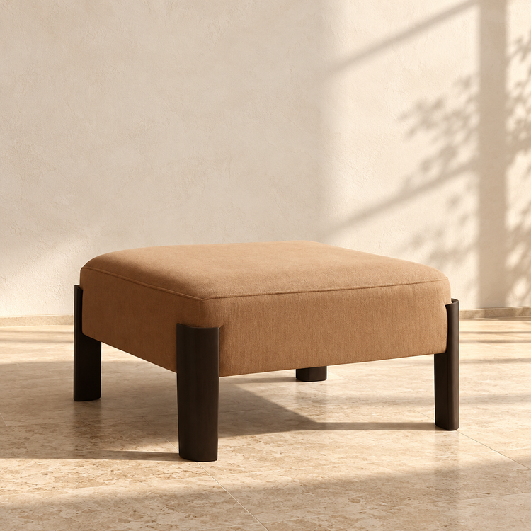 Chenille Square Ottoman Coffee Table against a cream limewash wall on a travertine floor in warm afternoon light
