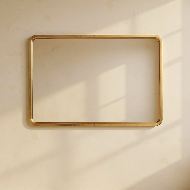 Brushed Brass Rectangular Wall Mirror against cream limewash with a softly reflected room