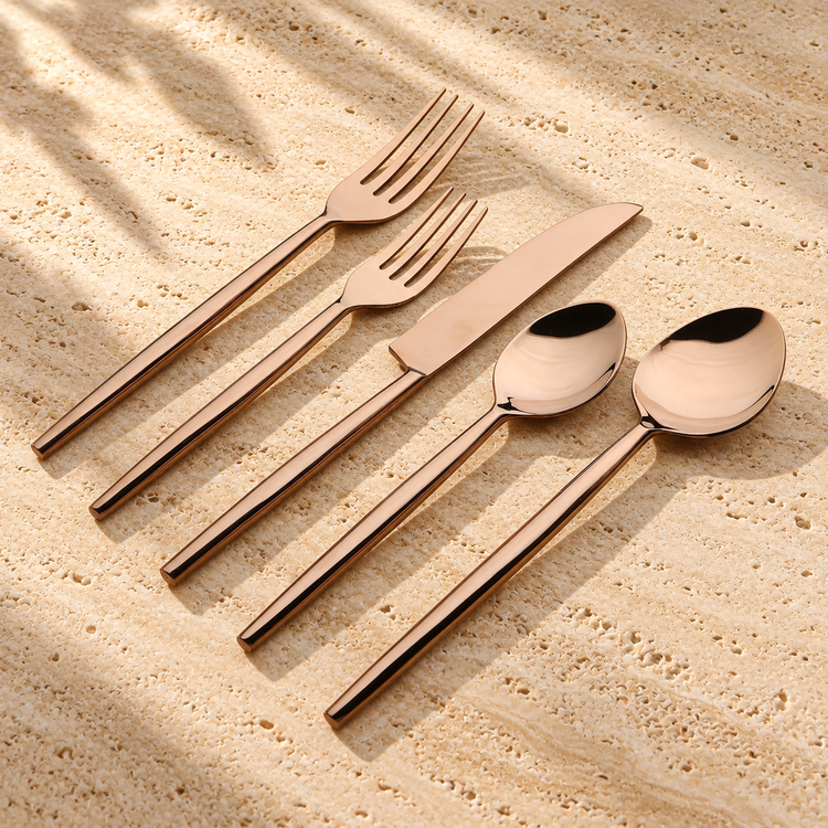 PVD-Coated Stainless Steel Flatware Set on a sunlit pale travertine counter