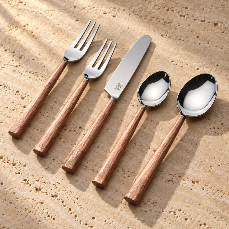 Textured Handle Stainless Flatware Set on a sunlit pale travertine counter
