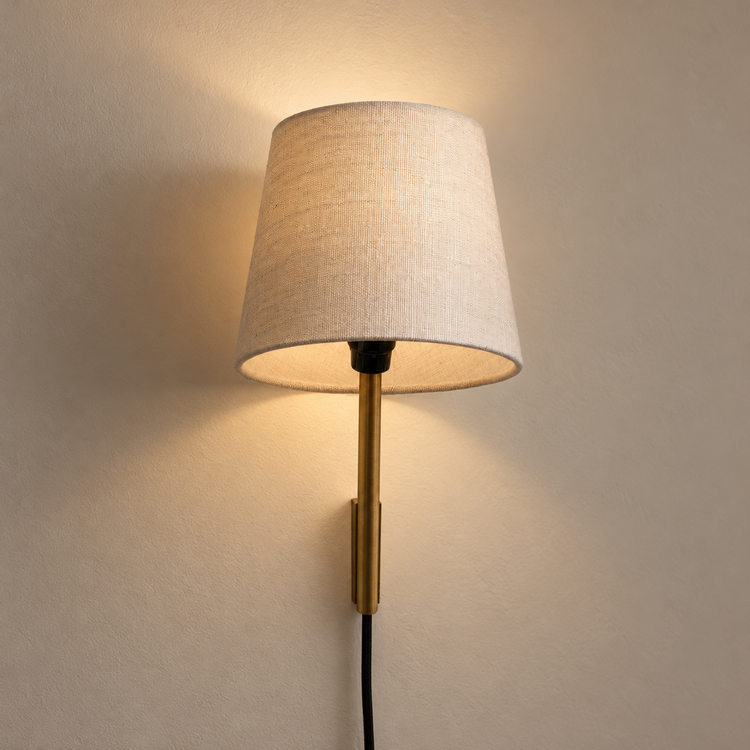 Tokyo Sconce illuminated against cream plaster