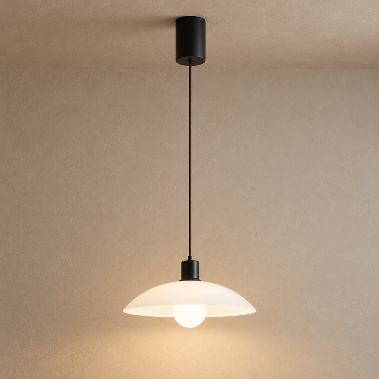 Matte Black Glass Dome Pendant Light in 1H / Warm White illuminated against cream plaster at dusk