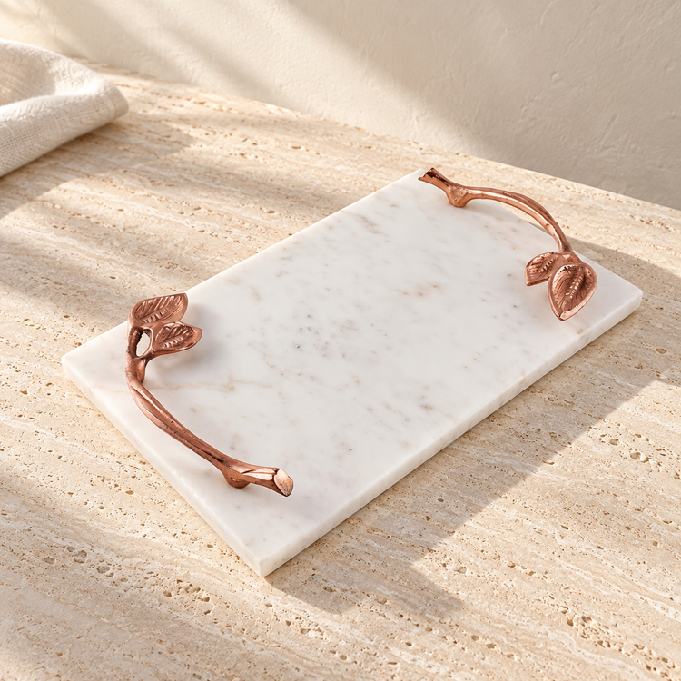 White Marble Tray with Copper Leaf Handles on a sunlit pale travertine counter