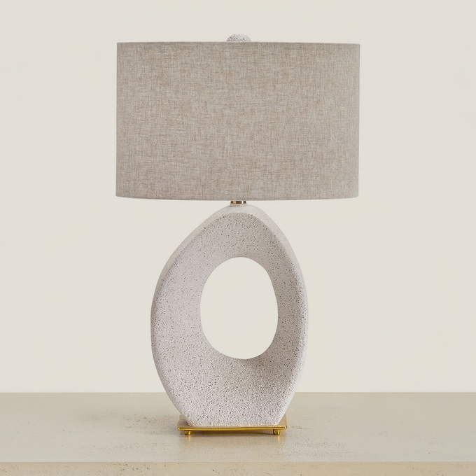 Trentlen table lamp with an open oval cream base and fabric shade