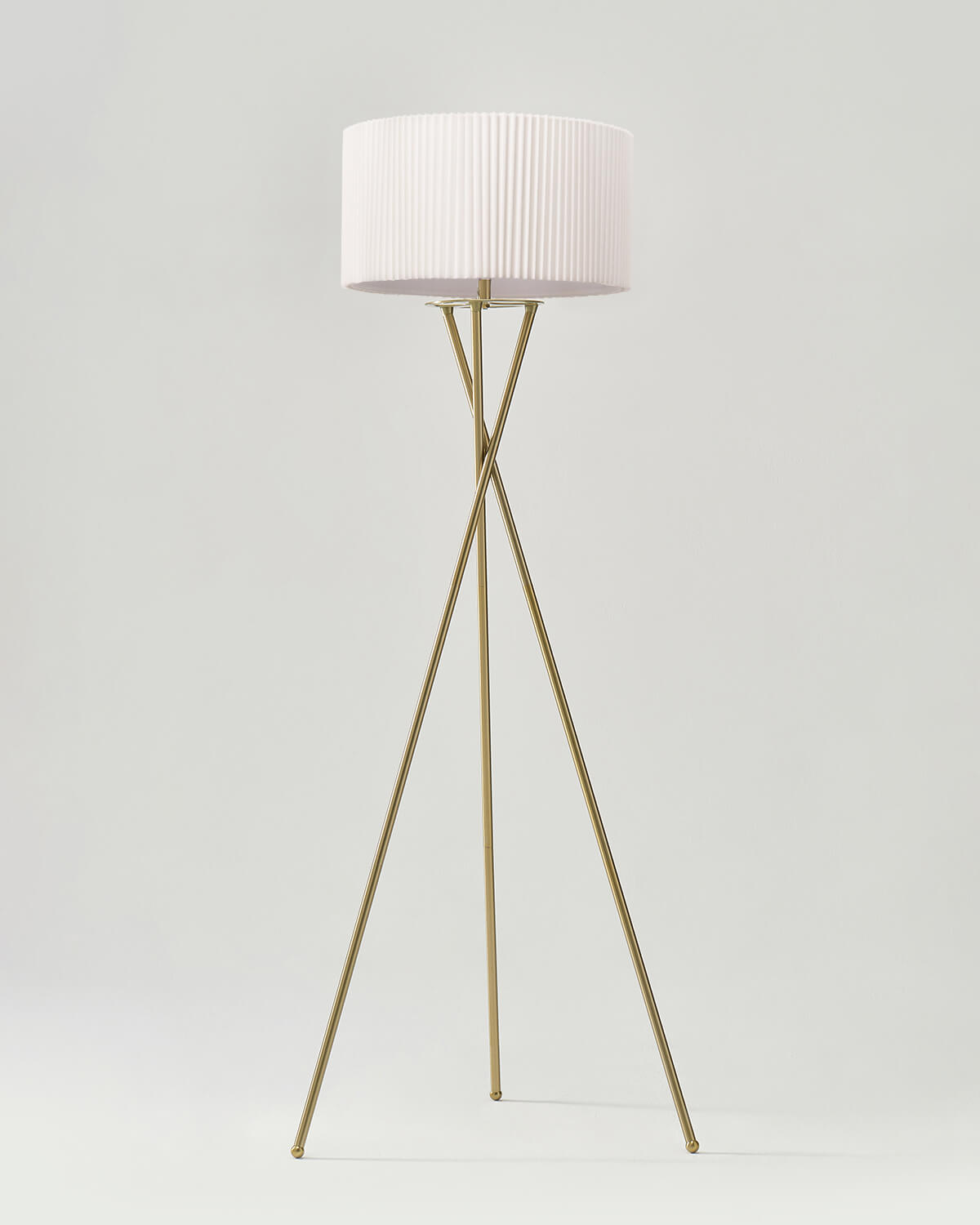 Crossed-Base Tripod Floor Lamp — Crossed brass-finish tripod base with pleated drum shade and LED source