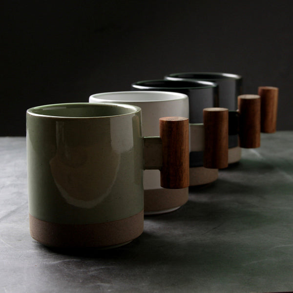 Wood-Handle Glazed Ceramic Mug — Glazed ceramic mug with a blocky wood-grain handle in five muted colorways