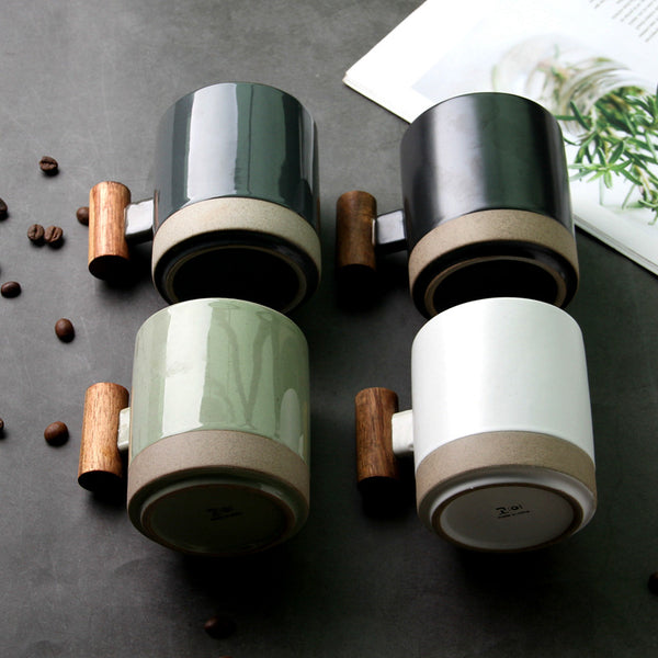 Wood-Handle Glazed Ceramic Mug holding a warm drink on a wooden table