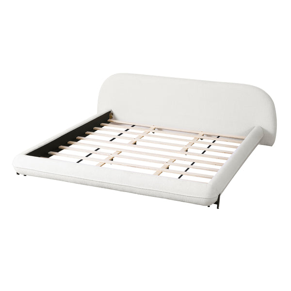 Cream curved bed frame viewed diagonally without mattress to reveal pale slats.