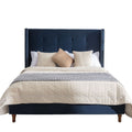 Tufted Velvet Wingback Queen Bed styled with linen bedding in a warm bedroom