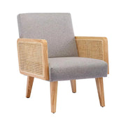 Rattan Cane Upholstered Accent Armchair styled on a sunlit patio with side table