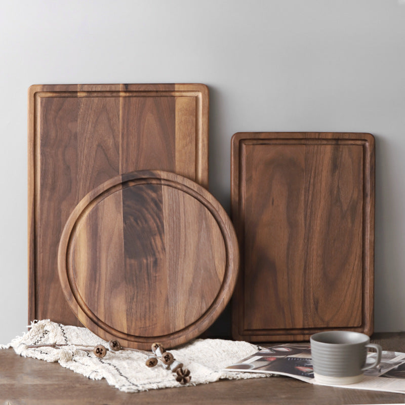 Black Walnut Wood Cutting Board styled on a countertop with bread and linen
