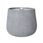 Ridged Concrete-Finish Bowl Fountain styled on a kitchen counter with produce
