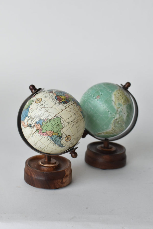 Antique-Style Mini Rotating Globe — Aged-cartography globe on a turned wood-grain base, desk-scaled