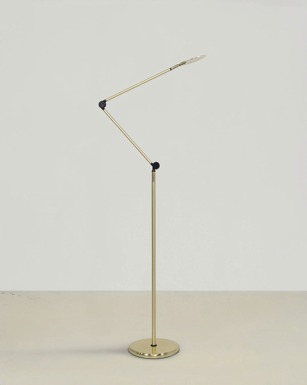 Brass articulated task floor lamp with black pivot joints, a slim LED head and round base