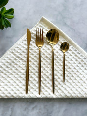 Gold-Finish Flatware Set 16-Piece in a styled home setting