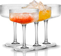 Ribbed Crystal-Clear Coupe Glass Set styled with linen bedding in a warm bedroom