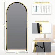Gold Arch Full-Length Floor Mirror hung above a console table with ceramics