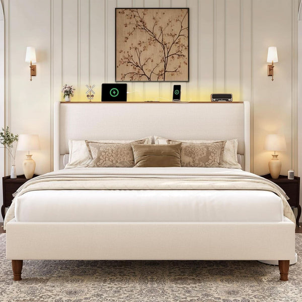 Cream wingback bed with lit shelf shown straight on beneath framed wall art.