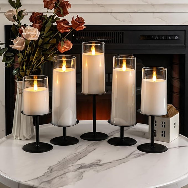 Five black with clear glass candle holders, cylindrical pillar holders with round bases