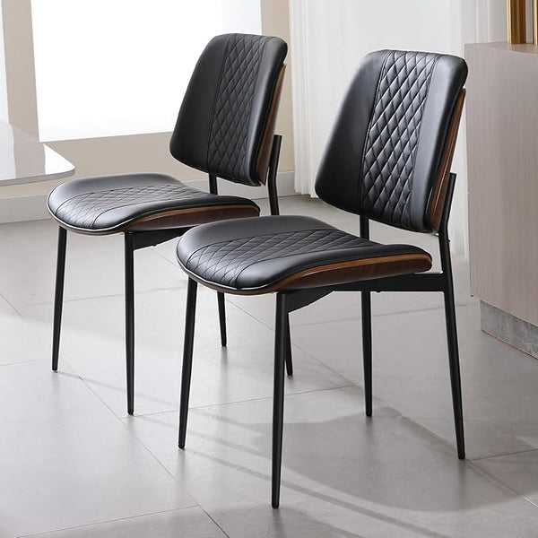 Two black dining chairs with quilted diamond grid, upright with quilted seat and backrest