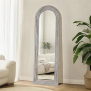 Arched Wood-Grain Floor Mirror hung above a console table with ceramics