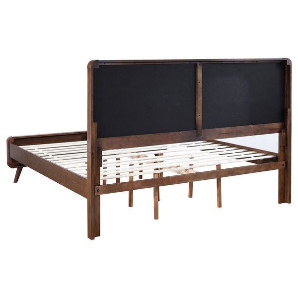 Rear view of the tufted-headboard bed frame showing dark back panels, wood slats and tapered legs.