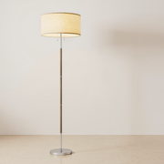 Floor lamp with a beige drum shade, two pull chains, wood-tone stem and silver round base