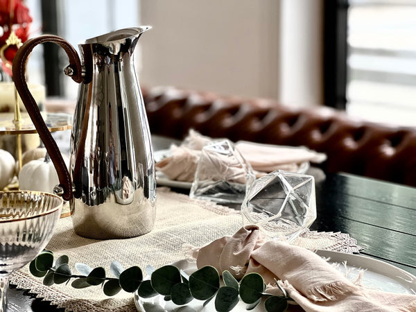 Close-up of material and construction detail — Polished Steel Leather-Handle Pitcher