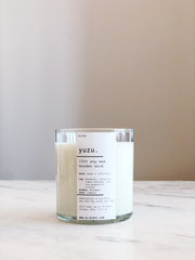 Yuzu Soy Wooden Wick Candle styled on a table with linen and ceramics