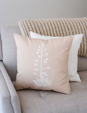 Agave Bloom Printed Linen-Blend Pillow layered on a neutral sofa with throw blanket