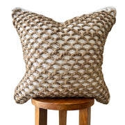 Braided Jute Woven Pillow Cover layered on a neutral sofa with throw blanket