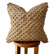 Braided Jute Woven Pillow Cover layered on a neutral sofa with throw blanket