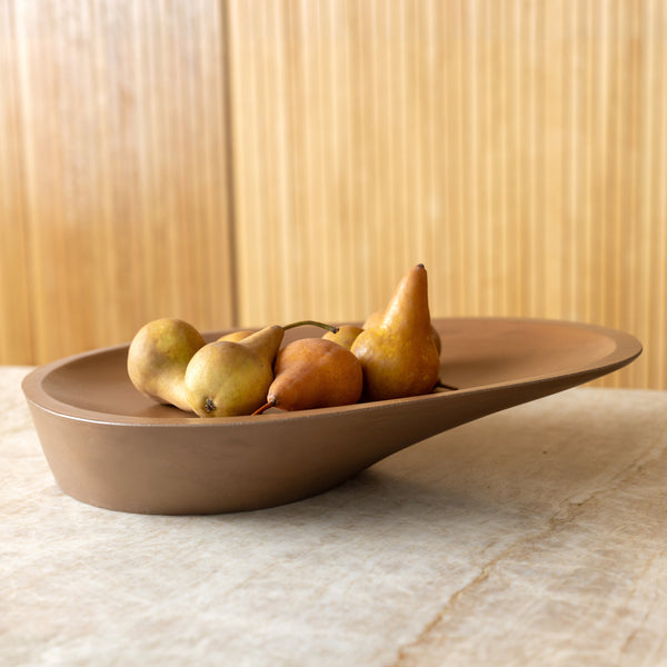 Asymmetric Matte Centerpiece Bowl styled on a kitchen counter with produce