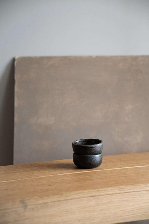 Rust-Glaze Stoneware Pinch Bowl styled on a kitchen counter with produce