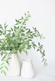 Arching Faux Ruscus Foliage Stem in a styled home setting
