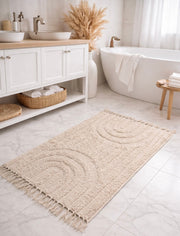Tufted Cotton Arch Bath Rug styled on a hardwood floor under a sofa
