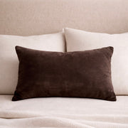 Chocolate Velvet Lumbar Pillow Cover layered on a neutral sofa with throw blanket