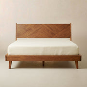Herringbone Wood Platform Bed Frame — Low-profile platform frame with a mirrored herringbone wood-grain headboard