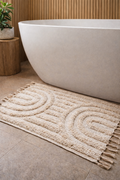 Tufted Cotton Arch Bath Rug — Hand-tufted cotton bath rug with raised arch motif and knotted fringe