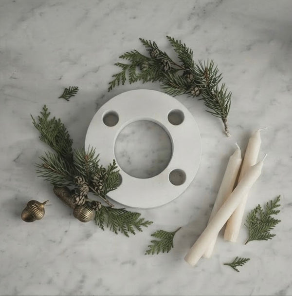 White candle holder, circular ring with four holes and central opening