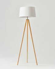 Linen Shade Tripod Floor Lamp — Tapered tripod floor lamp with fabric shade and warm wood-finish legs