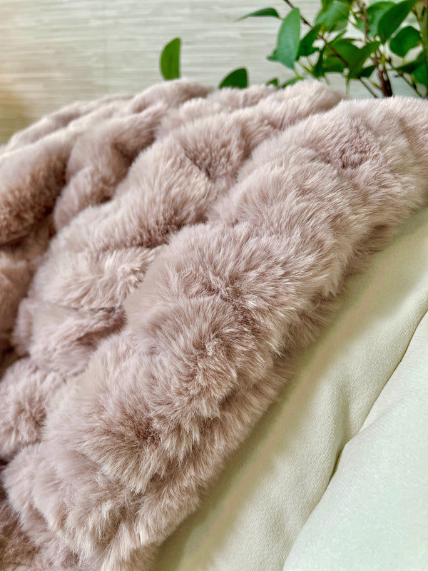 Channeled Faux Fur Throw Blanket draped over a linen sofa arm